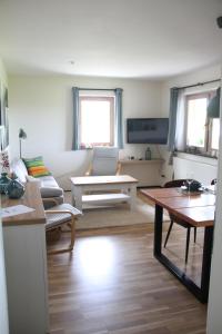 a living room with a couch and a table at Ferienwohnung Moin Eifel in Schleiden