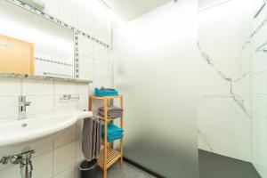 a bathroom with a sink and a mirror at Haus Muntschnei in Sankt Gallenkirch +28 photos