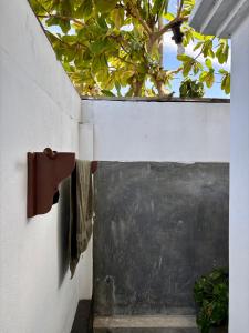 a door in a wall with a blackboard on it at ThePopos in Arugam Bay +10 photos