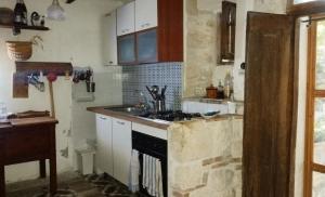 a kitchen with a sink and a stove top oven at Ai Limiti • 67 • StoneHouse in Palombaro