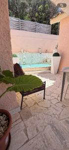 a patio with a bench and a swimming pool at Amore di Mare in Cagliari