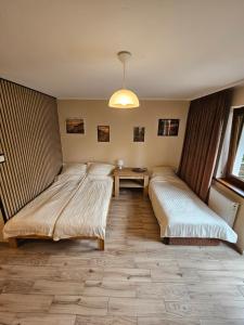 a bedroom with two beds and a desk in it at Pokoje DARMAT in Stegna +89 photos