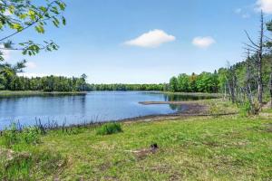 a view of a lake with trees in the background at Lang Lodge cabin in Drummond