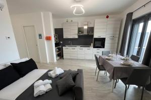 a living room with a dining table and a kitchen at Marisabella Suite 6 - 8 - 12 in Bari