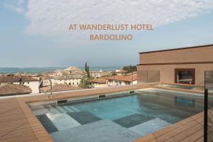 a swimming pool in front of a building at WANDERLUST VILLETTE a SCHIERA - Bardolino, Lago di Garda - Verona in Bardolino