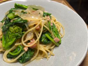 a plate of pasta and vegetables on a table at 泊まれるカフェやわらかそう in Koka +18 photos