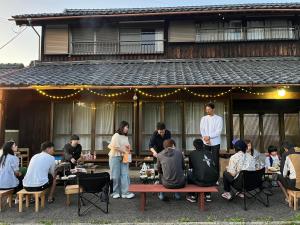 a group of people standing in front of a building at 泊まれるカフェやわらかそう in Koka