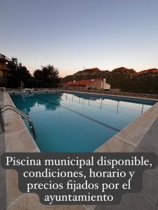 a swimming pool with the words pisina municipal diagnostic laboratories and horizons fl at Somianatura - Casa Rural Capafonts in Capafons