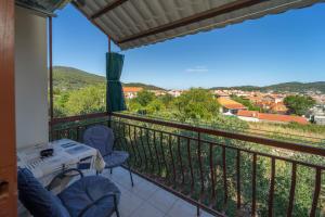a balcony with a table and chairs and a view at Protić Apartments in Vela Luka