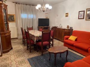 a living room with a table and a red couch at Tra le vie di Todi in Todi