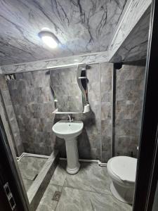 a bathroom with a sink and a toilet at Old Goris Hotel in Goris