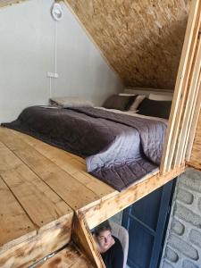 a man sitting in a chair in front of a bed at Old Goris Hotel in Goris