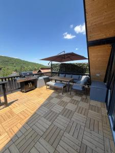 a patio with a table and chairs and an umbrella at Noora Nook in Sadu