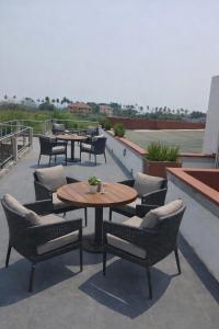 a patio with tables and chairs on a roof at Good Deeds Realty in Elmina