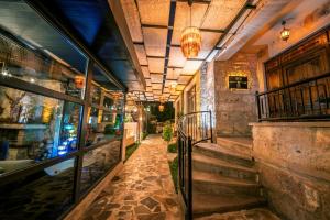 a hallway of a building with a staircase and a window at Louis Cappadocia in Uçhisar