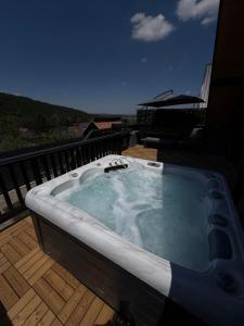 a jacuzzi tub on the deck of a house at Noora Nook in Sadu
