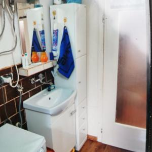 a bathroom with a toilet and a sink and a refrigerator at TANIE NOCLEGI u WOJTKA in Cieplice Slaskie Zdroj