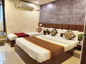 a bedroom with two beds in a room at AA Grand in Hyderabad
