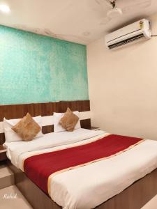 a bedroom with a bed with a red blanket at AA Grand in Hyderabad +11 photos