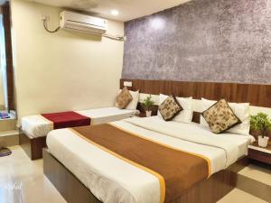 a hotel room with two beds in a room at AA Grand in Hyderabad