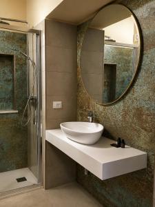 a bathroom with a sink and a mirror at Albergo Diffuso Ginevra Boutique Rooms - Palazzo Leosini - Residenze D'Epoca in LʼAquila +83 photos