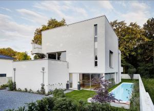 a white house with a swimming pool at ThehiddenLakehouse Pool Sauna Whirlpool in Duisburg