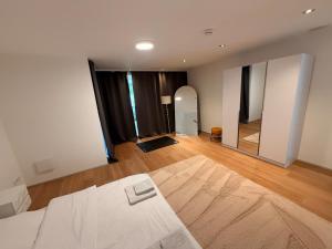 a room with a bed and a large mirror at ThehiddenLakehouse Pool Sauna Whirlpool in Duisburg +37 photos