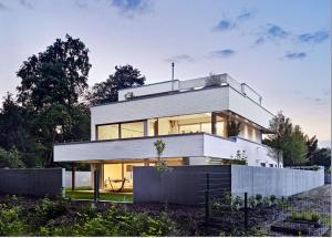 a large white house with a lot of windows at ThehiddenLakehouse Pool Sauna Whirlpool in Duisburg