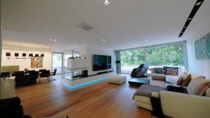 a large living room with a couch and a tv at ThehiddenLakehouse Pool Sauna Whirlpool in Duisburg