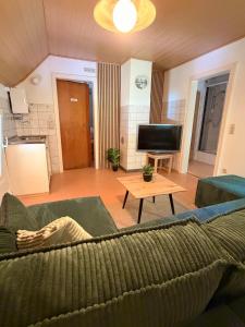 a living room with a couch and a table at Ferienhaus Hirschglück in Alpirsbach