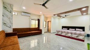 a large room with a bed and a couch at JB Resort in Mhow