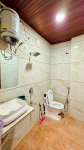 a bathroom with a toilet and a sink at JB Resort in Mhow +23 photos