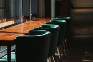 a row of chairs around a table in a conference room at Hotel Airport Elite Suit Near Delhi Airport in New Delhi