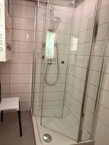 a shower with a glass door in a bathroom at Ferienhaus Hirschglück in Alpirsbach +25 photos
