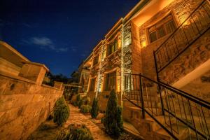 a building with a staircase in front of it at night at Louis Cappadocia in Uçhisar