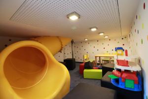 a childrens room with a slide and a play area at alla Papa in Obernzenn +26 photos