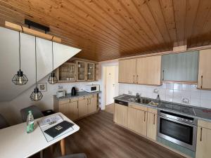 a kitchen with wooden cabinets and a counter top at Gästewohnung in Algermissen in Algermissen