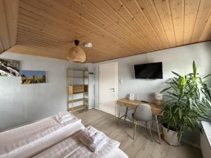 a bedroom with a bed and a wooden ceiling at Gästewohnung in Algermissen in Algermissen