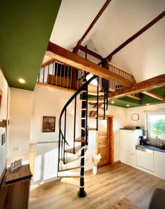 a spiral staircase in a room with a kitchen at Ferienhaus Schwalmblick in Schwalmstadt