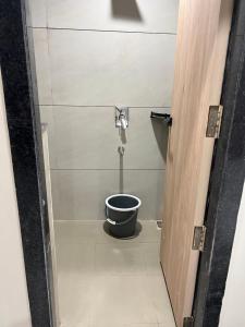 a bathroom with a toilet with a bucket at hotel a sons in Chittaurgarh