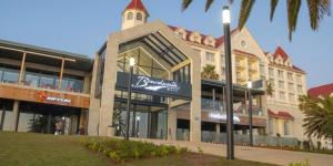 a large building with a sign in front of it at The Willow Whispers guest house in Gqeberha