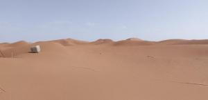 a truck in the sand in the desert at Camp la mer de sable in Mhamid +3 photos