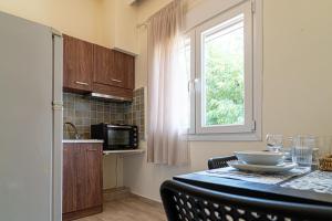 a kitchen with a table with a bowl on it at Akrogiali Studios Michaniona in Nea Michaniona