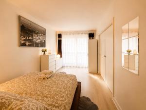 a bedroom with a bed with a stuffed animal on it at Champs elysees apartment 4 in Paris