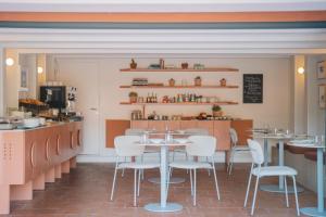 a restaurant with tables and chairs and a counter at Maison Nova - Boutique Hôtel & Spa in Collioure