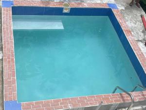 a large blue swimming pool in a brick building at The Jungle Escape Apartment 01 in Malgretoute