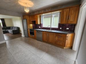 a kitchen with a sink and a stove top oven at Hill house Westport in Castlebar +3 photos