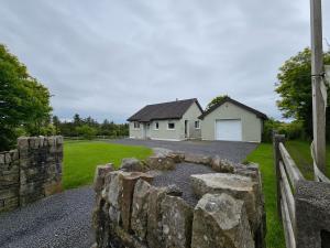 a stone retaining wall in front of a house at Hill house Westport in Castlebar