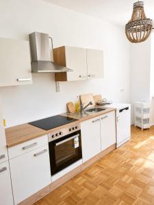 a kitchen with white cabinets and a stove top oven at Apartment Gletscher & Fluß in Penk +23 photos
