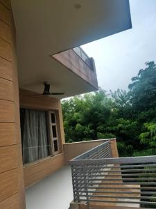 a balcony with a window and stairs in a house at Om Homestay in Panchkula